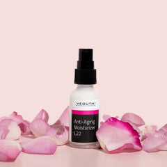 YEOUTH Anti-Aging Moisturizer L22 bottle surrounded by pink rose petals on a soft pink background.