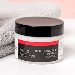 YEOUTH Retinol Eye Cream jar with hyaluronic acid and tripeptide complex on soft towel background, clean skincare product.
